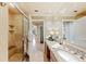 Elegant bathroom features a large mirror, granite counters and a glass enclosed shower with a built-in bench at 511 Duque Rd, Lutz, FL 33549