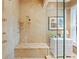 Shower featuring marble tile, a built-in bench, multiple shower heads, and glass doors at 511 Duque Rd, Lutz, FL 33549