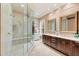 Spacious bathroom featuring glass enclosed shower, double sinks with vanity at 511 Duque Rd, Lutz, FL 33549