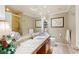Bathroom with dual sink vanity with granite counters, tiled floors and framed art at 511 Duque Rd, Lutz, FL 33549