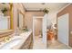 Bathroom featuring double sinks with marble counters, wood cabinets and fixtures at 511 Duque Rd, Lutz, FL 33549