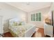 Cozy bedroom featuring crown molding, hardwood floors, plantation shutters, and a ceiling fan at 511 Duque Rd, Lutz, FL 33549