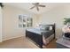Cozy bedroom with neutral carpet, ceiling fan and a large window with plantation shutters at 511 Duque Rd, Lutz, FL 33549