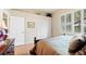 Comfortable bedroom featuring a ceiling fan, plantation shutters, and an ensuite bathroom at 511 Duque Rd, Lutz, FL 33549