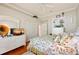 Bedroom with a TV on a dresser, a floral pattern bedspread, and hardwood flooring at 511 Duque Rd, Lutz, FL 33549