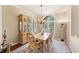 Bright dining room featuring wooden furniture, hardwood floors, and a large window for natural light at 511 Duque Rd, Lutz, FL 33549