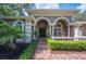 Stunning home entrance with brick pathway, fountain, manicured landscaping and charming architectural details at 511 Duque Rd, Lutz, FL 33549