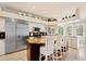 Chef's kitchen with stainless steel appliances, a central island, and stylish bar stool seating at 511 Duque Rd, Lutz, FL 33549