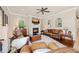 Cozy living room with fireplace, wooden floors, an elegant ceiling fan and lots of space to relax at 511 Duque Rd, Lutz, FL 33549