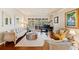 Cozy living room with hardwood floors, a grand piano, and shuttered windows for abundant natural light at 511 Duque Rd, Lutz, FL 33549