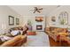 Bright living room with a fireplace, ceiling fan, wood floors, and elegant leather furniture at 511 Duque Rd, Lutz, FL 33549