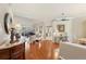 Open-concept living space with hardwood floors, piano, and view into other rooms at 511 Duque Rd, Lutz, FL 33549