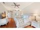 Comfortable main bedroom with wood floors, ceiling fan, sitting area, and ample natural light at 511 Duque Rd, Lutz, FL 33549