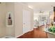 Hallway view leading to a spacious main bedroom featuring wood floors and large windows at 511 Duque Rd, Lutz, FL 33549