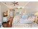 Bright and relaxing main bedroom with a ceiling fan, wooden floors, and ample storage at 511 Duque Rd, Lutz, FL 33549