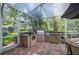 Well-equipped outdoor kitchen with built-in grill and stainless-steel appliances, perfect for entertaining at 511 Duque Rd, Lutz, FL 33549