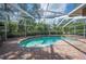 Screened pool with lush landscaping offers a private and serene outdoor oasis at 511 Duque Rd, Lutz, FL 33549