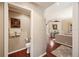 Hallway view into the powder room with hardwood flooring and decorative hanging towels at 511 Duque Rd, Lutz, FL 33549