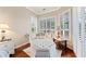 Cozy sitting area with plantation shutters, wooden floors, and stylish furniture details at 511 Duque Rd, Lutz, FL 33549