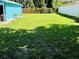 Green backyard with a wooden fence for privacy, perfect for outdoor activities at 5130 Pine Grove S Ter, Gulfport, FL 33707