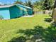 Fenced backyard with grassy area and an outdoor patio at 5130 Pine Grove S Ter, Gulfport, FL 33707
