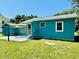 Backyard patio with shade and room for grilling. Grassy area surrounding concrete pad at 5130 Pine Grove S Ter, Gulfport, FL 33707
