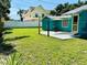 Large backyard with an outdoor patio and a well-maintained lawn at 5130 Pine Grove S Ter, Gulfport, FL 33707