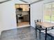 View from sunroom to a modern kitchen featuring stainless steel appliances and granite countertops at 5130 Pine Grove S Ter, Gulfport, FL 33707