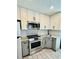Modern kitchen featuring stainless steel appliances, granite countertops, and stylish tile backsplash at 5130 Pine Grove S Ter, Gulfport, FL 33707