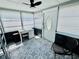 Cozy sunroom features patterned tile flooring, lots of natural light, and comfortable seating at 5130 Pine Grove S Ter, Gulfport, FL 33707