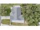 A birds-eye view of the roof of the house with mature trees and a well-kept lawn at 5283 Bevens Ave, Spring Hill, FL 34608