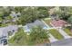 A high angle showing the blue house with mature trees and an extended driveway at 5283 Bevens Ave, Spring Hill, FL 34608