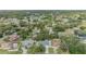 A high angle showing the blue house surrounded by trees in a neighborhood at 5283 Bevens Ave, Spring Hill, FL 34608