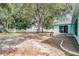 Spacious backyard featuring mature trees and a charming fire pit area at 5283 Bevens Ave, Spring Hill, FL 34608