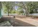 Expansive backyard with mature trees and a cozy fire pit area at 5283 Bevens Ave, Spring Hill, FL 34608