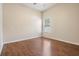 Cozy bedroom featuring wood floors, a window for natural light, and ample space at 5283 Bevens Ave, Spring Hill, FL 34608