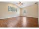 Spacious bedroom featuring a vaulted ceiling, wood floors, and large windows for natural light at 5283 Bevens Ave, Spring Hill, FL 34608
