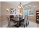 Elegant dining room featuring chandelier, sconces, large window, and stylish table set at 5283 Bevens Ave, Spring Hill, FL 34608