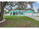 Charming turquoise home with a well-manicured lawn and a two-car garage at 5283 Bevens Ave, Spring Hill, FL 34608