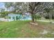 Inviting turquoise home with lush landscaping and mature trees in a serene setting at 5283 Bevens Ave, Spring Hill, FL 34608