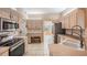 Updated kitchen with stainless steel appliances, a built-in desk and tile flooring at 5283 Bevens Ave, Spring Hill, FL 34608