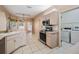 Bright kitchen with stainless steel appliances and a convenient laundry area at 5283 Bevens Ave, Spring Hill, FL 34608