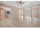 Open-concept living area featuring tile floors, columns, and view to the outdoor pool at 5283 Bevens Ave, Spring Hill, FL 34608