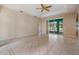Open-concept living room with tiled floors and sliding glass doors that leads to an outdoor area at 5283 Bevens Ave, Spring Hill, FL 34608