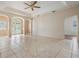 Spacious living room with tiled floors, archways, and view to the outdoor area at 5283 Bevens Ave, Spring Hill, FL 34608