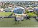 The backyard has a pool, a wood pier, and a boat dock, ideal for relaxing and enjoying waterfront living at 538 Crystal Dr, Madeira Beach, FL 33708