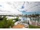 Backyard with outdoor patio, white picket fence, dock, and canal front access, ideal for relaxation and entertainment at 538 Crystal Dr, Madeira Beach, FL 33708