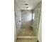 Bright remodeled bathroom with custom shower, stone tile floor, and shower bench at 538 Crystal Dr, Madeira Beach, FL 33708