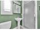 Bathroom featuring a pedestal sink, and walk-in shower with glass door at 538 Crystal Dr, Madeira Beach, FL 33708