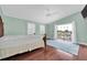 Well-lit bedroom featuring a king bed, hardwood floors, and a view of the water at 538 Crystal Dr, Madeira Beach, FL 33708